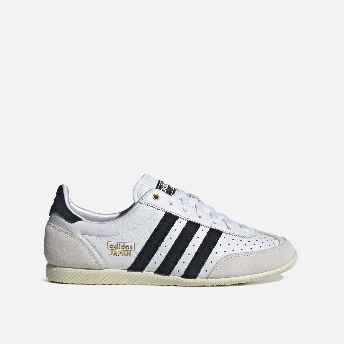 Adidas Japan limited edition sneakers with white leather upper and gold accents, side view