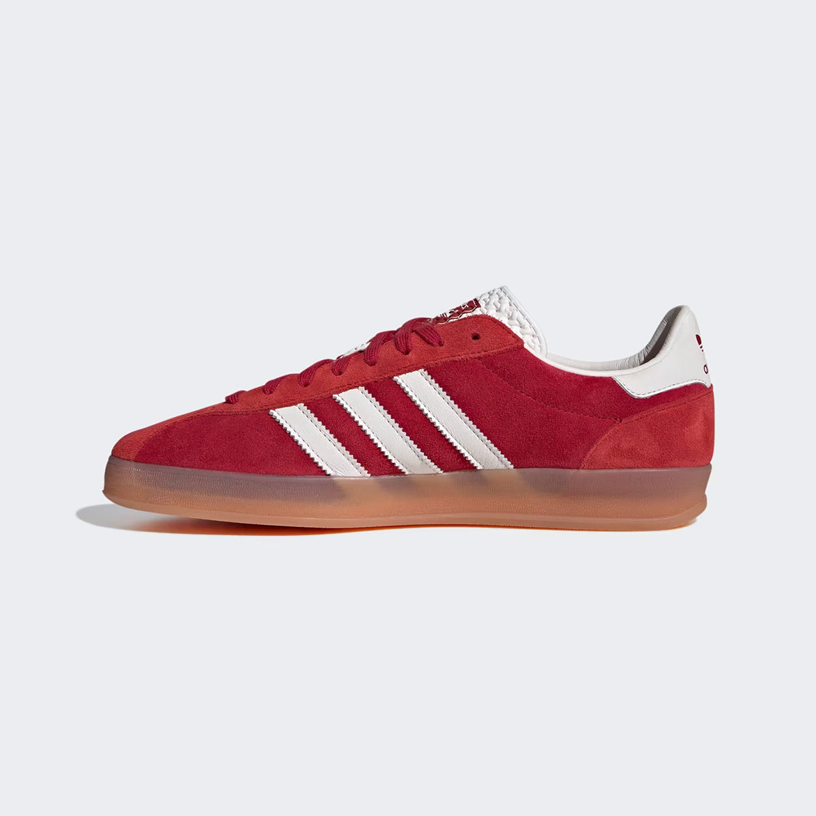 Close-up of Victory Red Gazelle Indoor Pro sneakers showcasing the suede texture and white leather details.