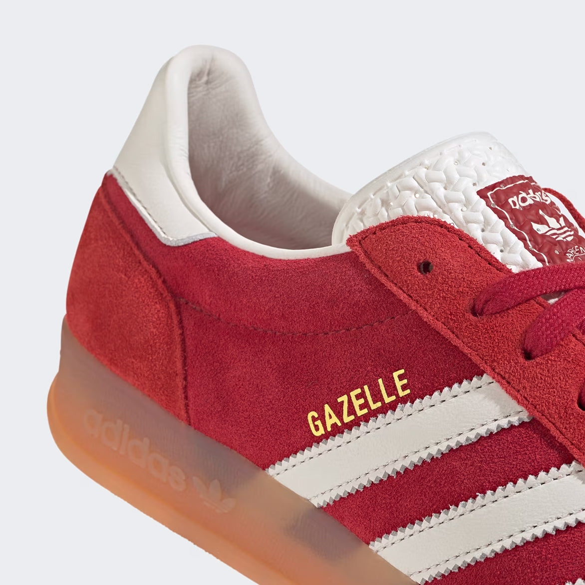 Side view of the Gazelle Indoor Pro sneakers in Team Victory Red, highlighting the classic Three Stripes.