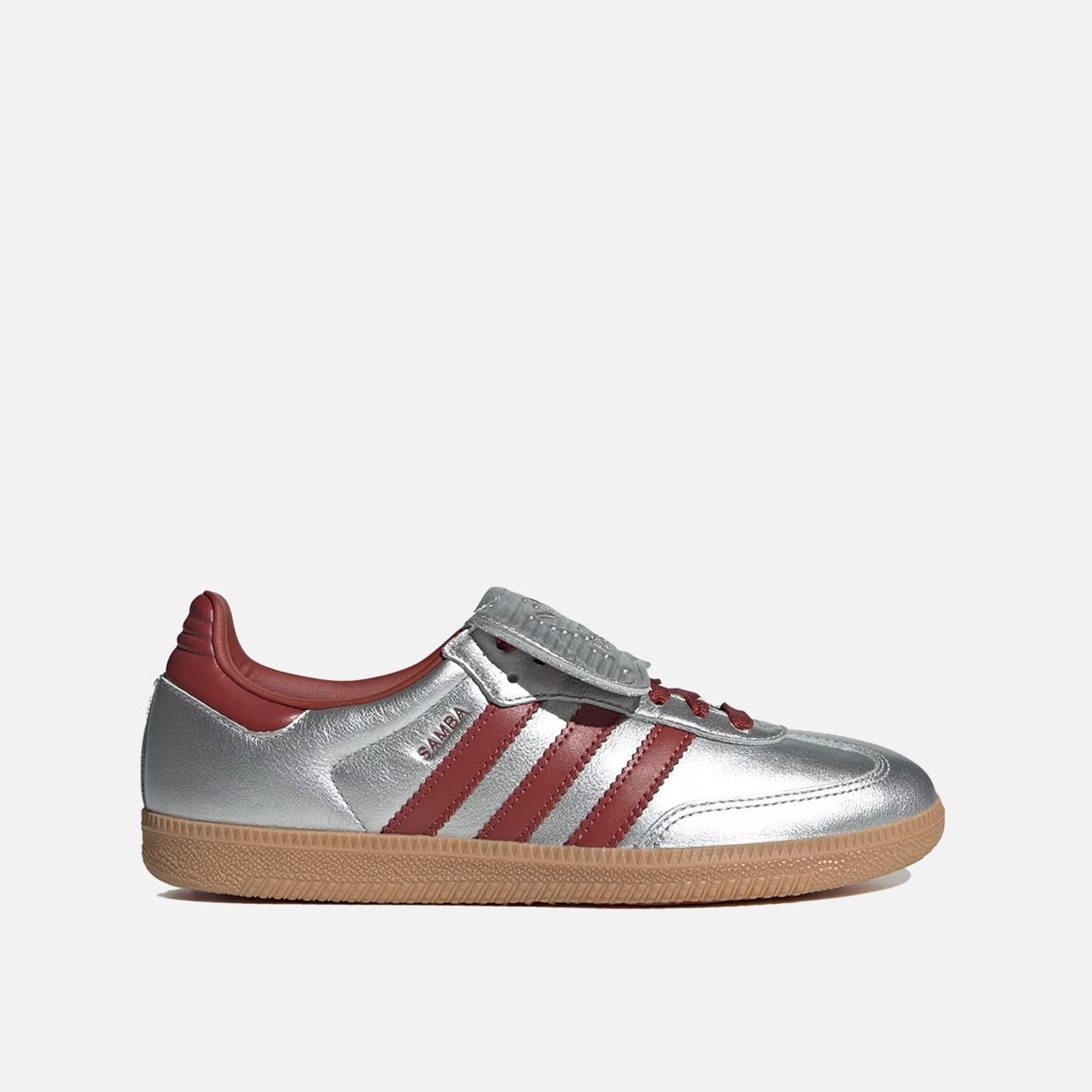 Close-up of Samba Long Tongue women's silver sneakers showcasing the embossed adidas logo and metallic finish.