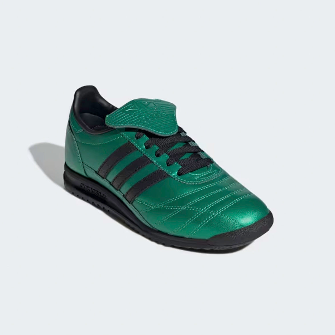 Side angle of Adidas SL 72 OG Womens Retro Sneakers, featuring contrasting black 3-Stripes and laces.