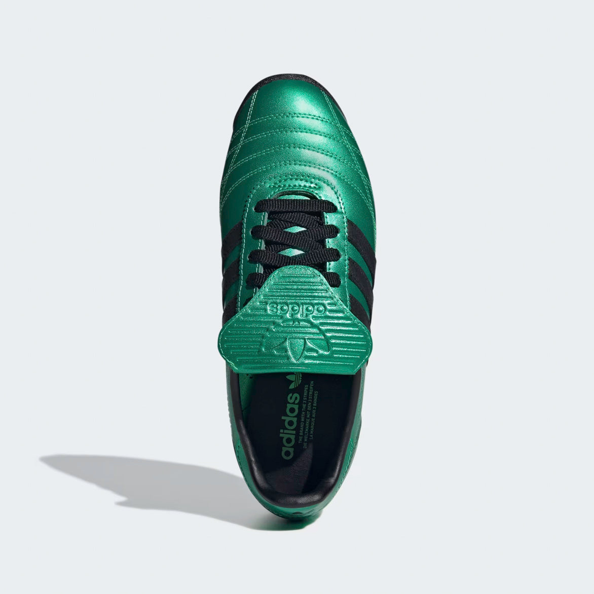 Side angle of Adidas SL 72 OG Womens Retro Sneakers, featuring contrasting black 3-Stripes and laces.