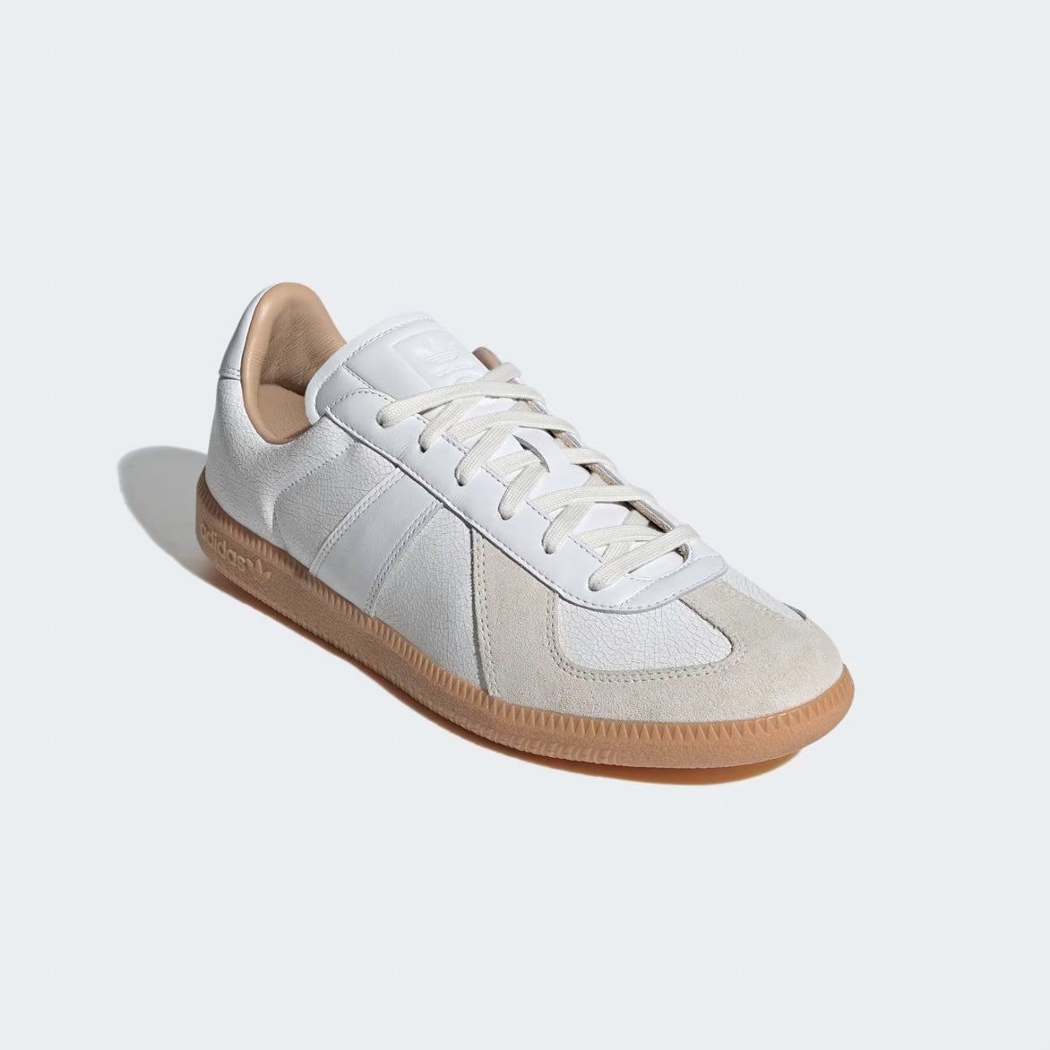 Close-up of the elegant white cracked leather upper and suede T-toe cap on the luxury sneakers.