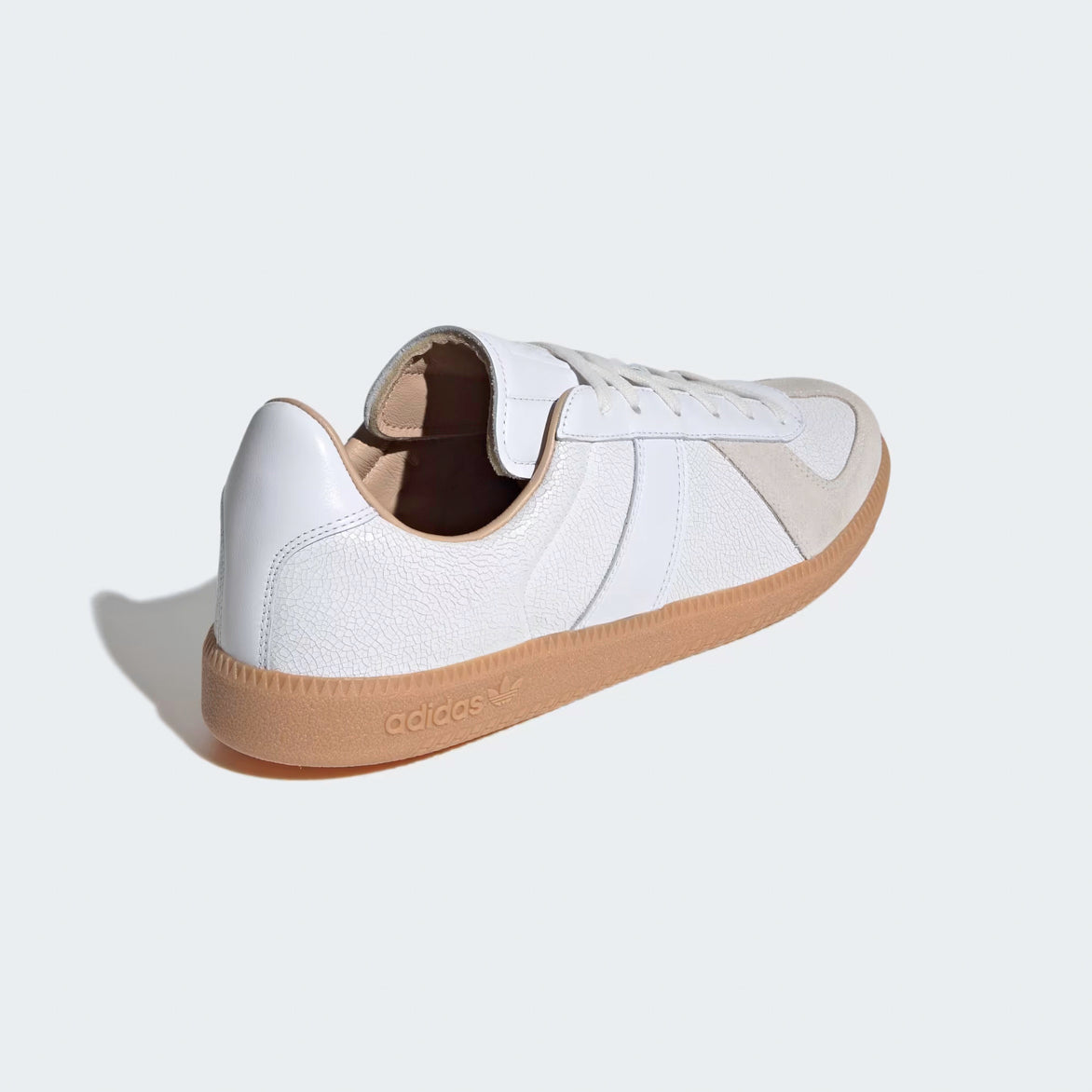 Model wearing Cloud White luxury sneakers with gum sole, showcasing their versatility and style.