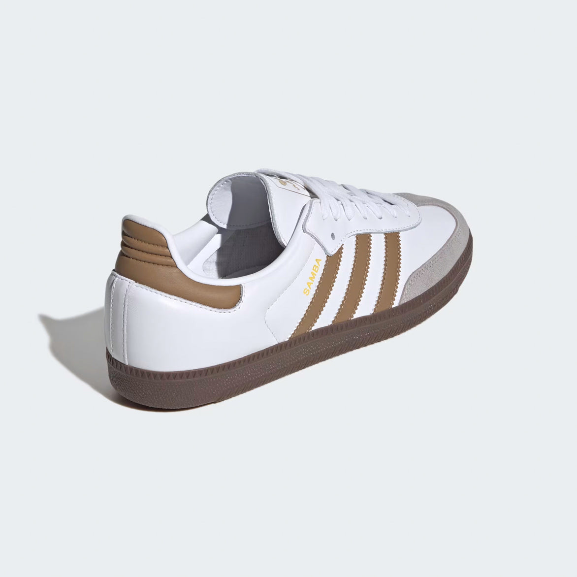 Front view of the white sneakers featuring classic Adidas Samba OG design