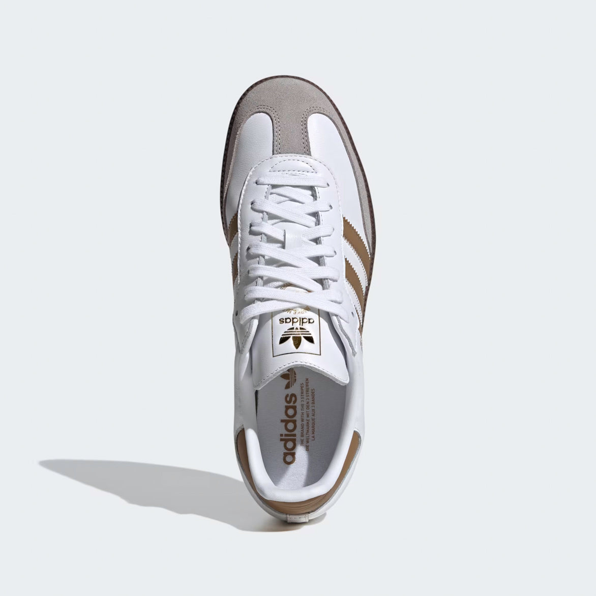 Front view of the white sneakers featuring classic Adidas Samba OG design