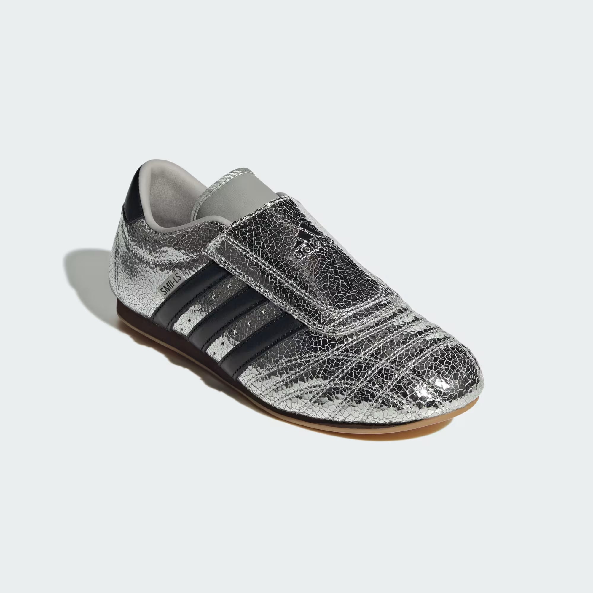 Side view of Adidas taekwondo streetwear shoes for sale in a modern urban setting