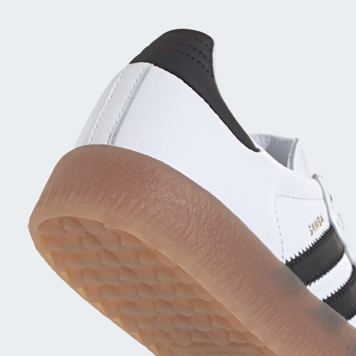 Close-up of the Adidas Sambae Cloud Whites unique design featuring the Trefoil logo and gold Samba branding.