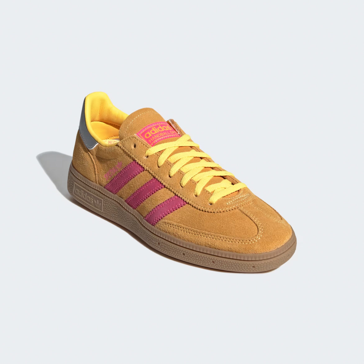 Close-up of the womens handball sneakers showcasing the pink and yellow tongue tag and laces.