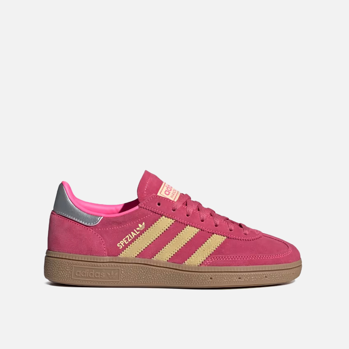 Side angle of lucid-pink suede Handball Spezial retro shoes on model wearing cropped denim