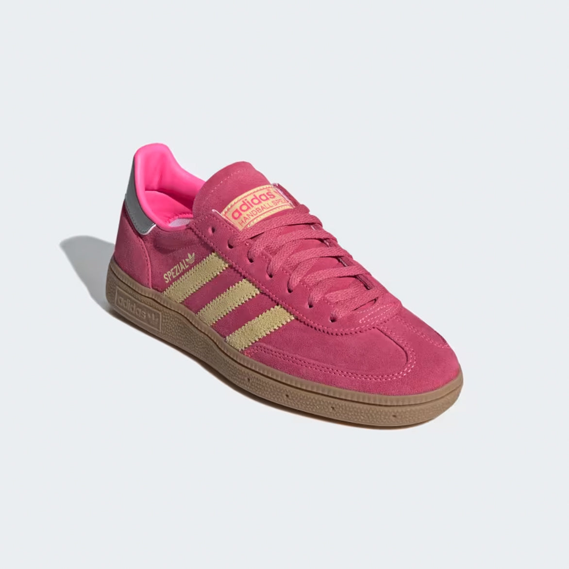 Top-down flat-lay of the limited women’s retro sneakers showing pink laces and yellow tongue tag