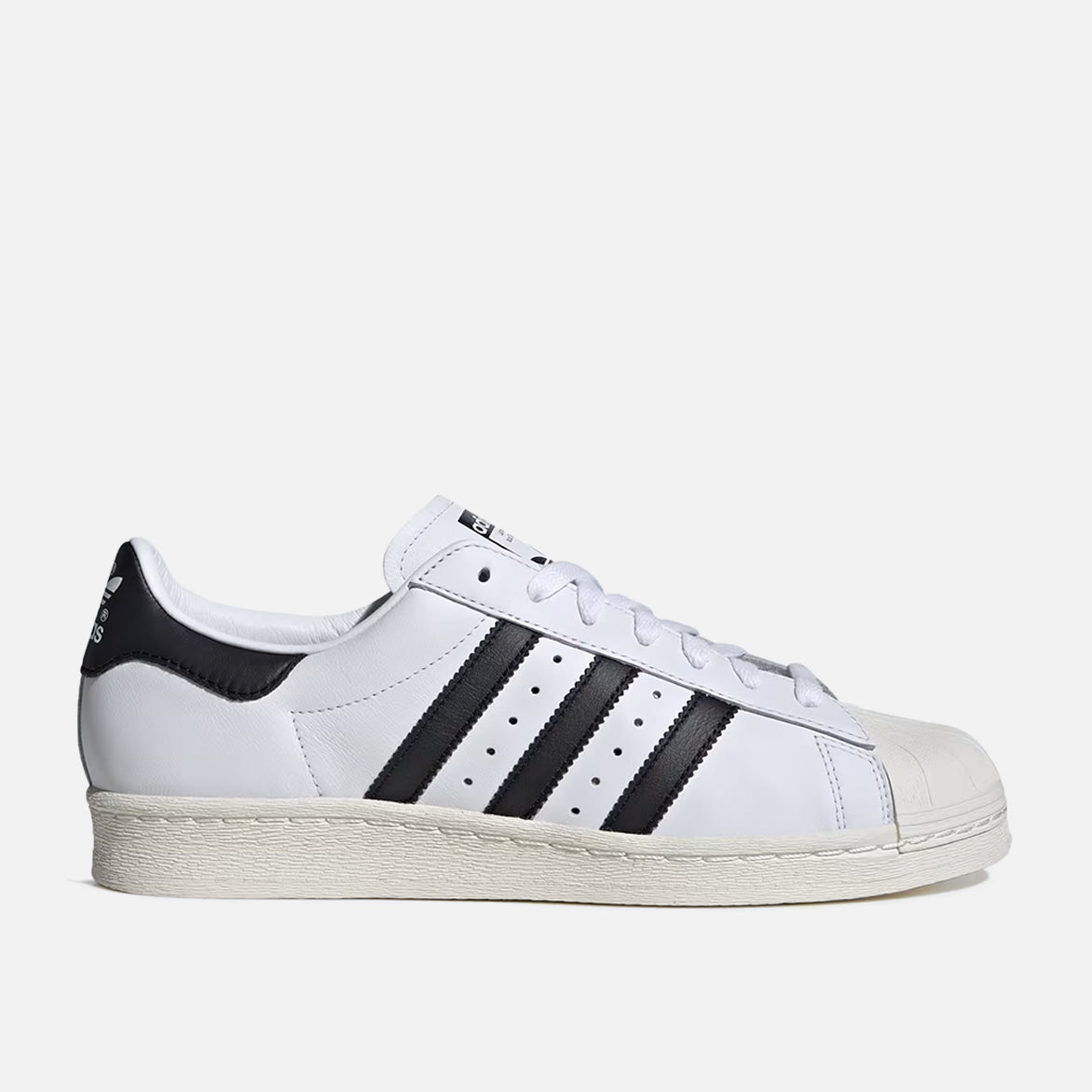 Side view of Adidas Superstar 82 showcasing the white leather upper and black detailing. Side view of Adidas Superstar 82 showcasing the white leather upper and black detailing.
