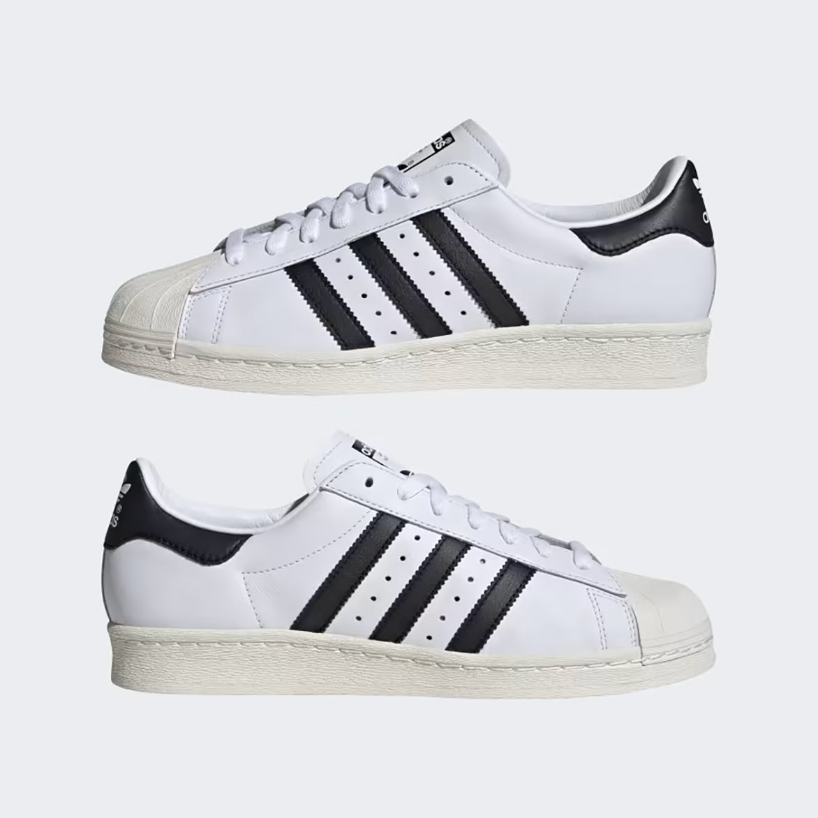 Close-up of the iconic rubber shell toe on the Adidas Superstar 82 sneakers.