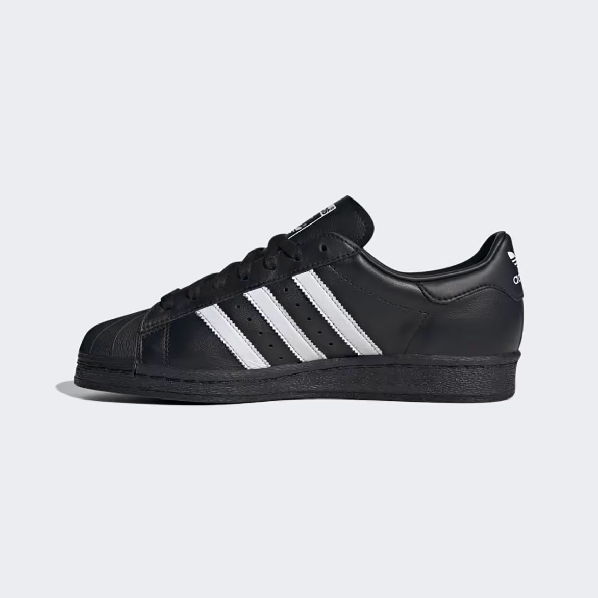 Side view of adidas superstar 1982 core black with white accents