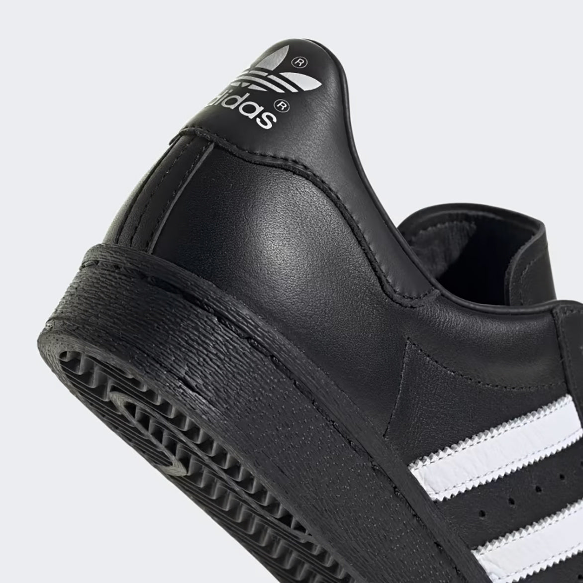 Side view of adidas superstar 1982 core black with white accents