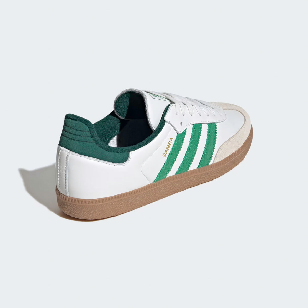 Close-up of the gum rubber outsole of Adidas Samba OG sneakers in a streetwear setting
