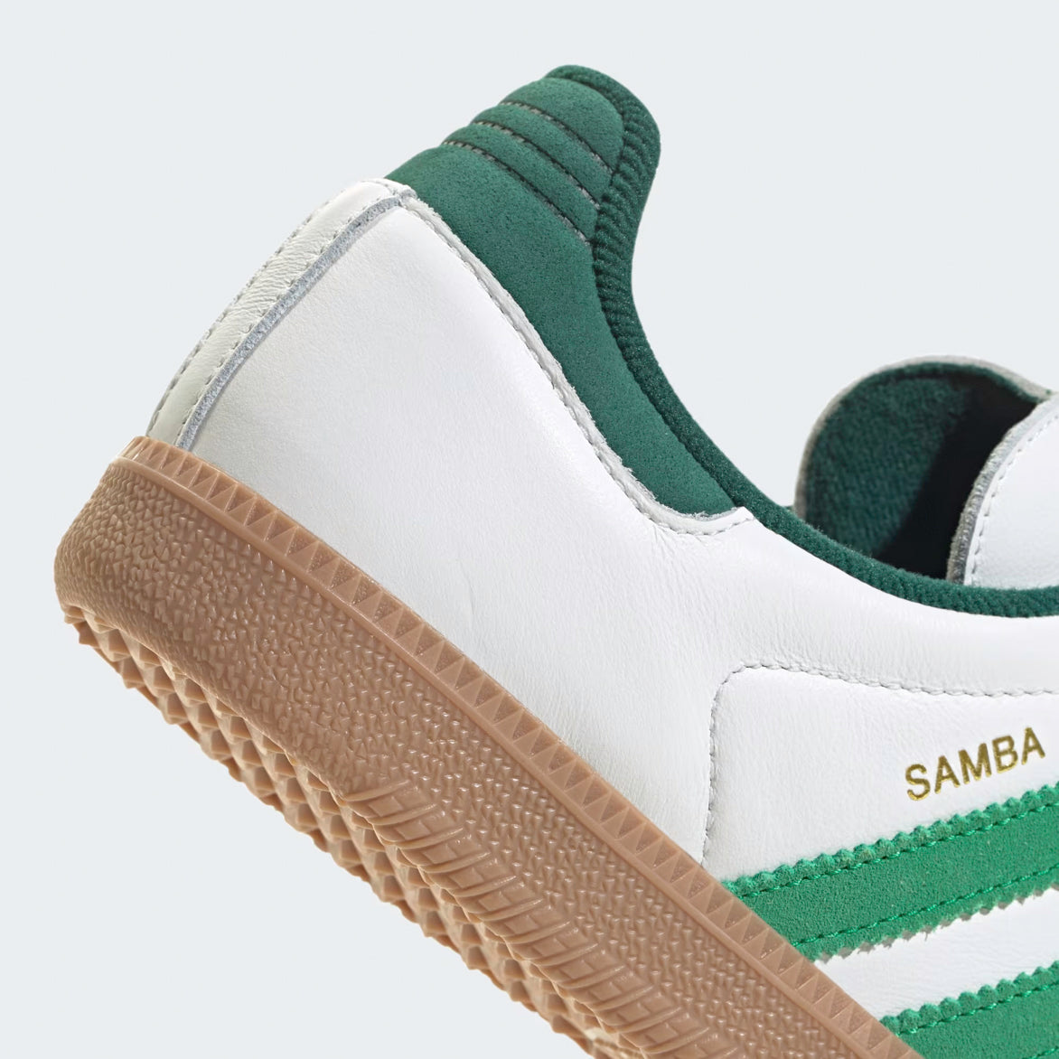 Close-up of the gum rubber outsole of Adidas Samba OG sneakers in a streetwear setting