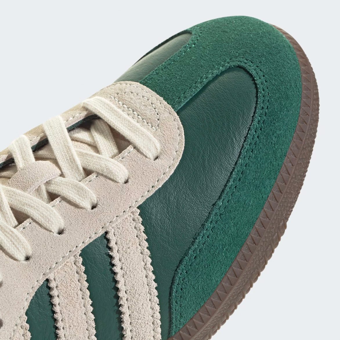 Close-up of Adidas Samba OG Sneakers in Collegiate Green, highlighting the suede and leather materials.
