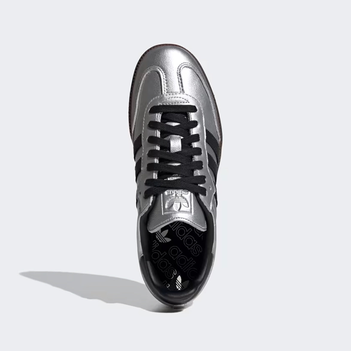 Close-up detail of the debossed Trefoil branding and gum rubber outsole