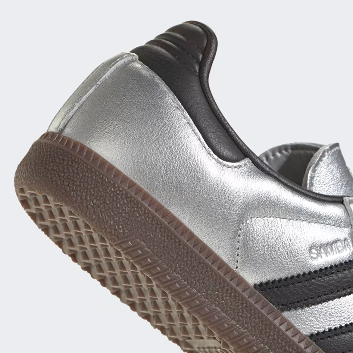 Side profile showing the sleek design of the Adidas Samba OG in silver