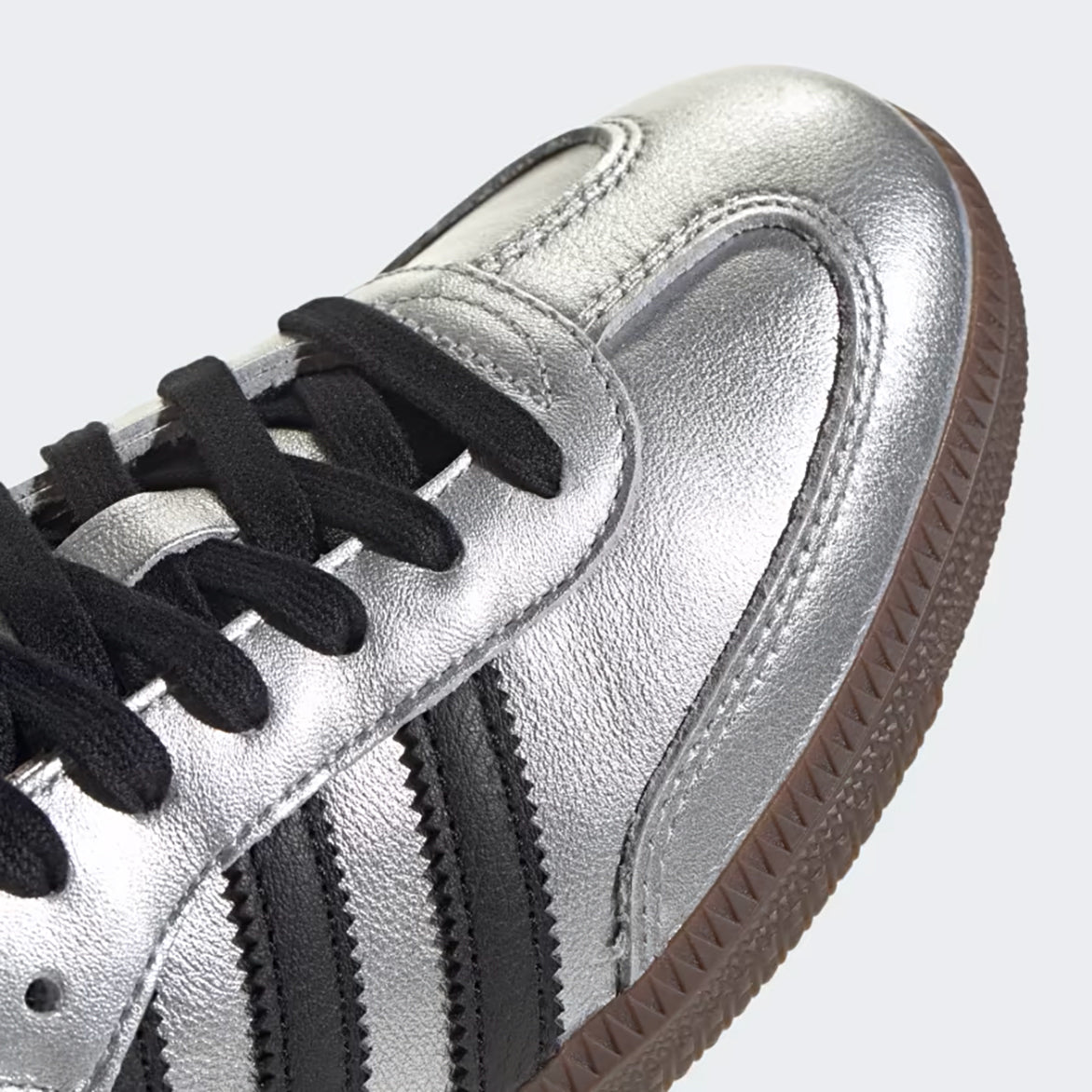 Front view of metallic silver womens sneakers with black accents