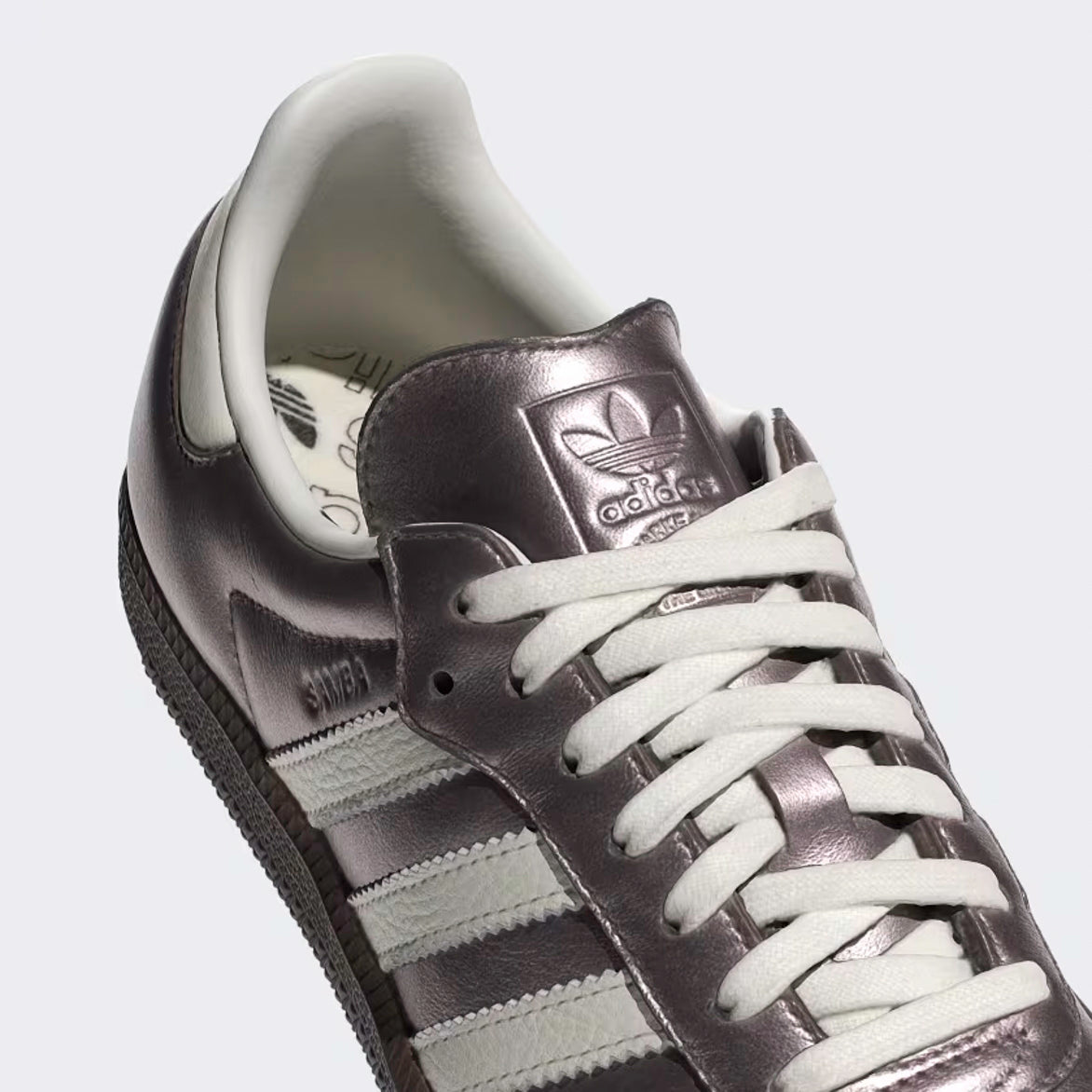 Close-up of the gum sole and debossed Trefoil branding on adidas samba OG purple shoes