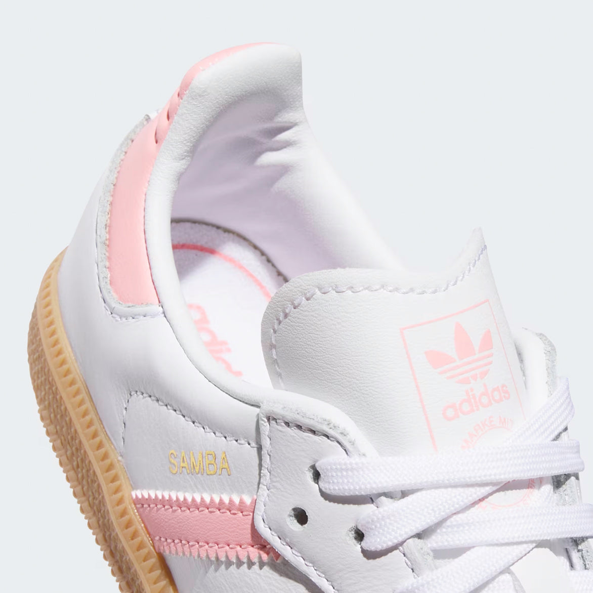 Top-down angle showing white laces, pink Trefoil tongue tag, and grey suede toebox on Adidas Samba OG