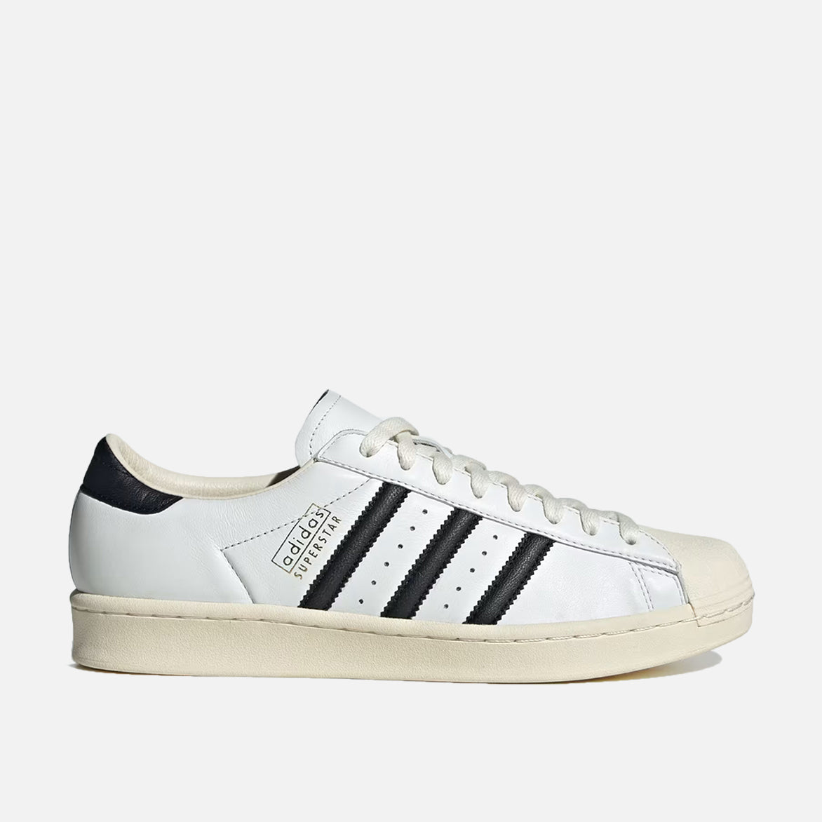 Side view of Adidas Superstar Vintage Sneakers in Core White and Black, highlighting the shell toe design.