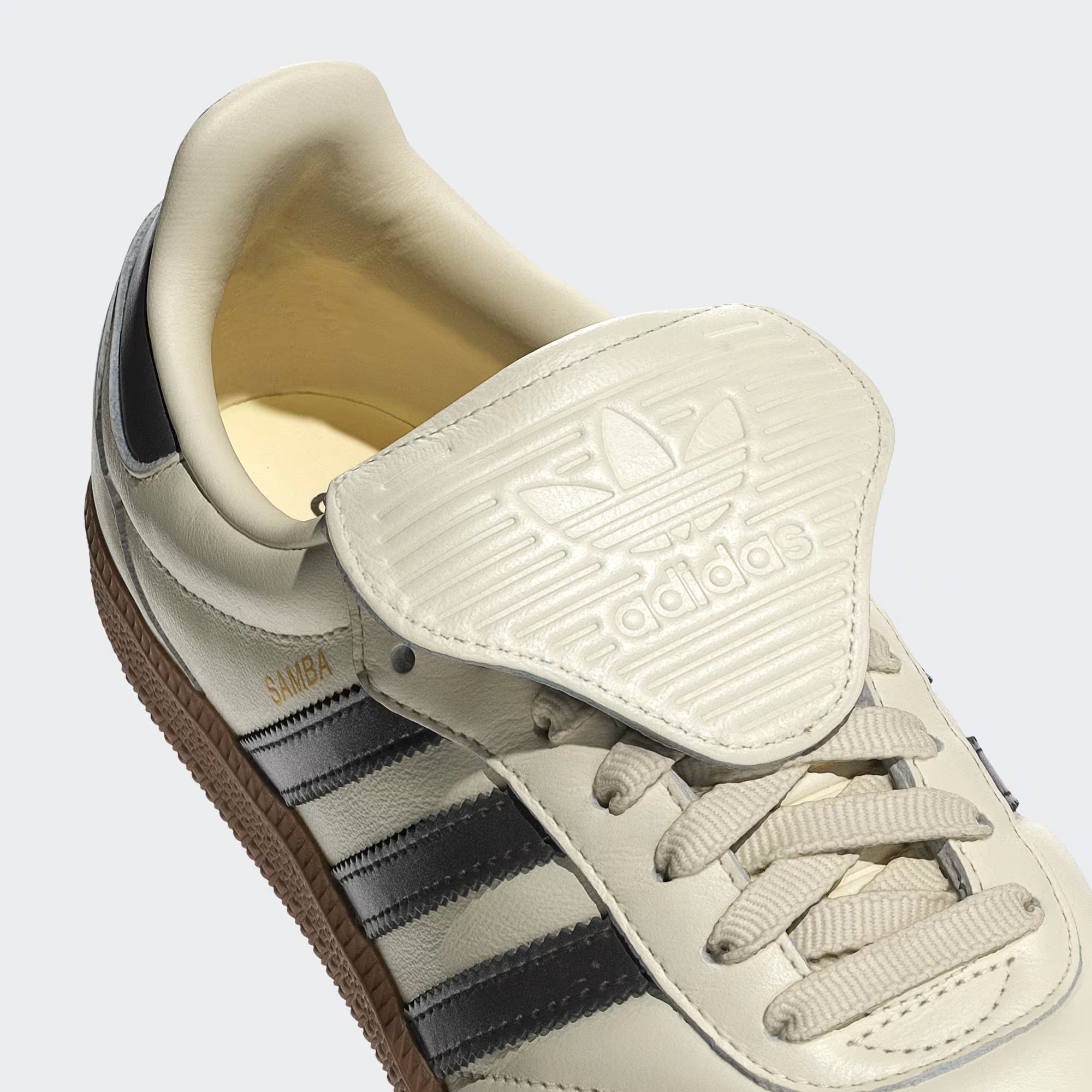 Side view of adidas WMNS Samba Long Tongue sneakers in cream white and black, highlighting the leather upper and gum sole.