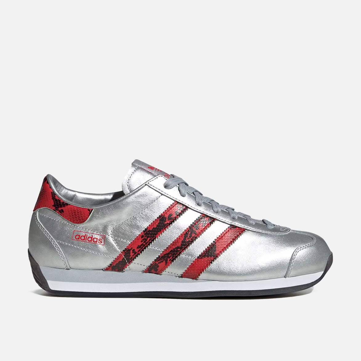 Side view of Retro Horizon sneakers showing silver metallic finish and textured red stripes