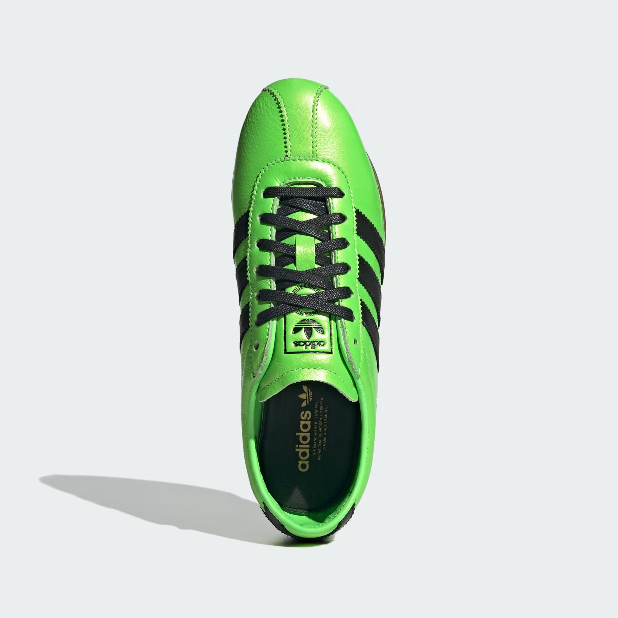 Side view of Adidas Womens Limited Edition Tokyo Sneakers in Solar Green, highlighting the unique design and texture.