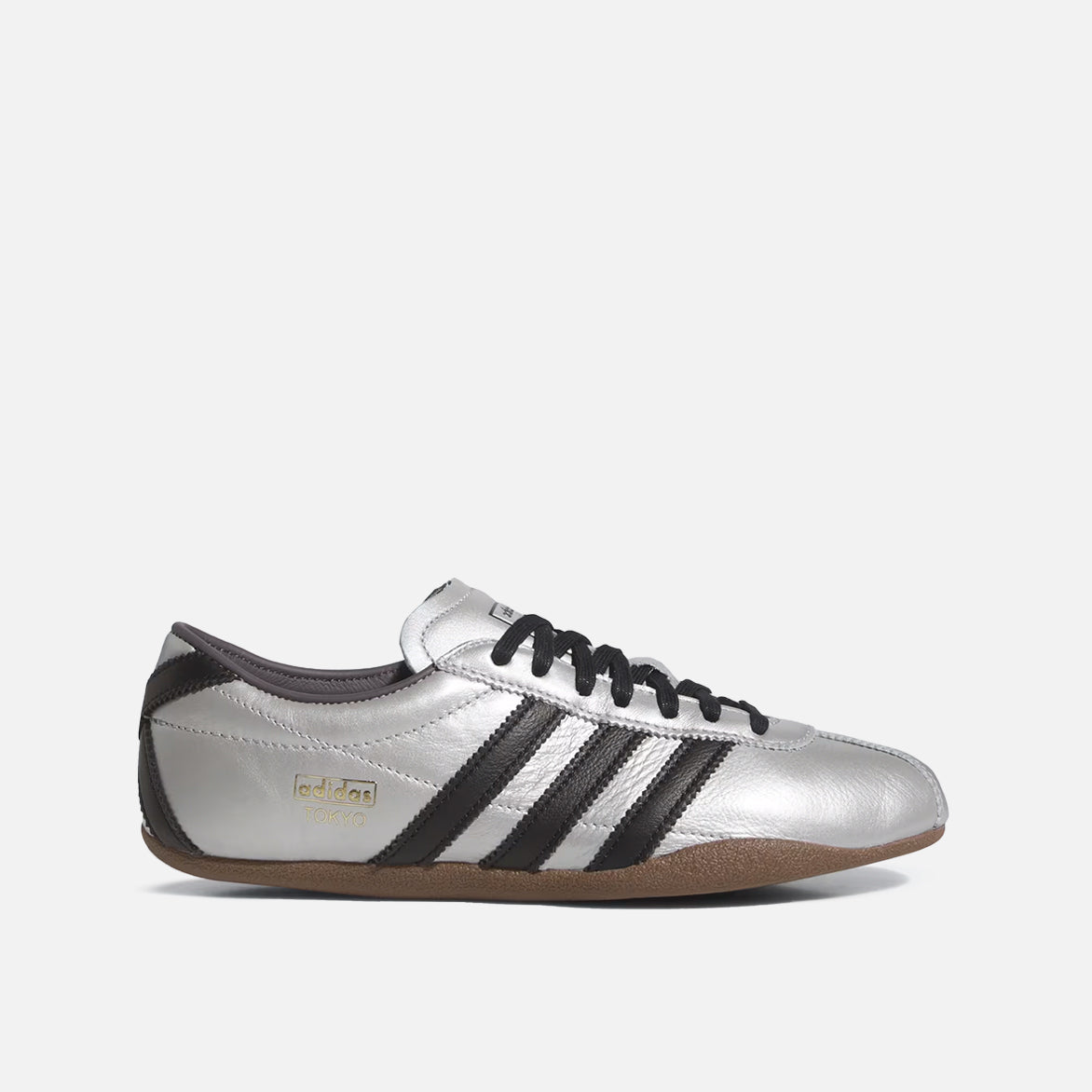 Side view of Adidas Women's Silver Metallic Sneakers, highlighting serrated overlays and low-profile sole.
