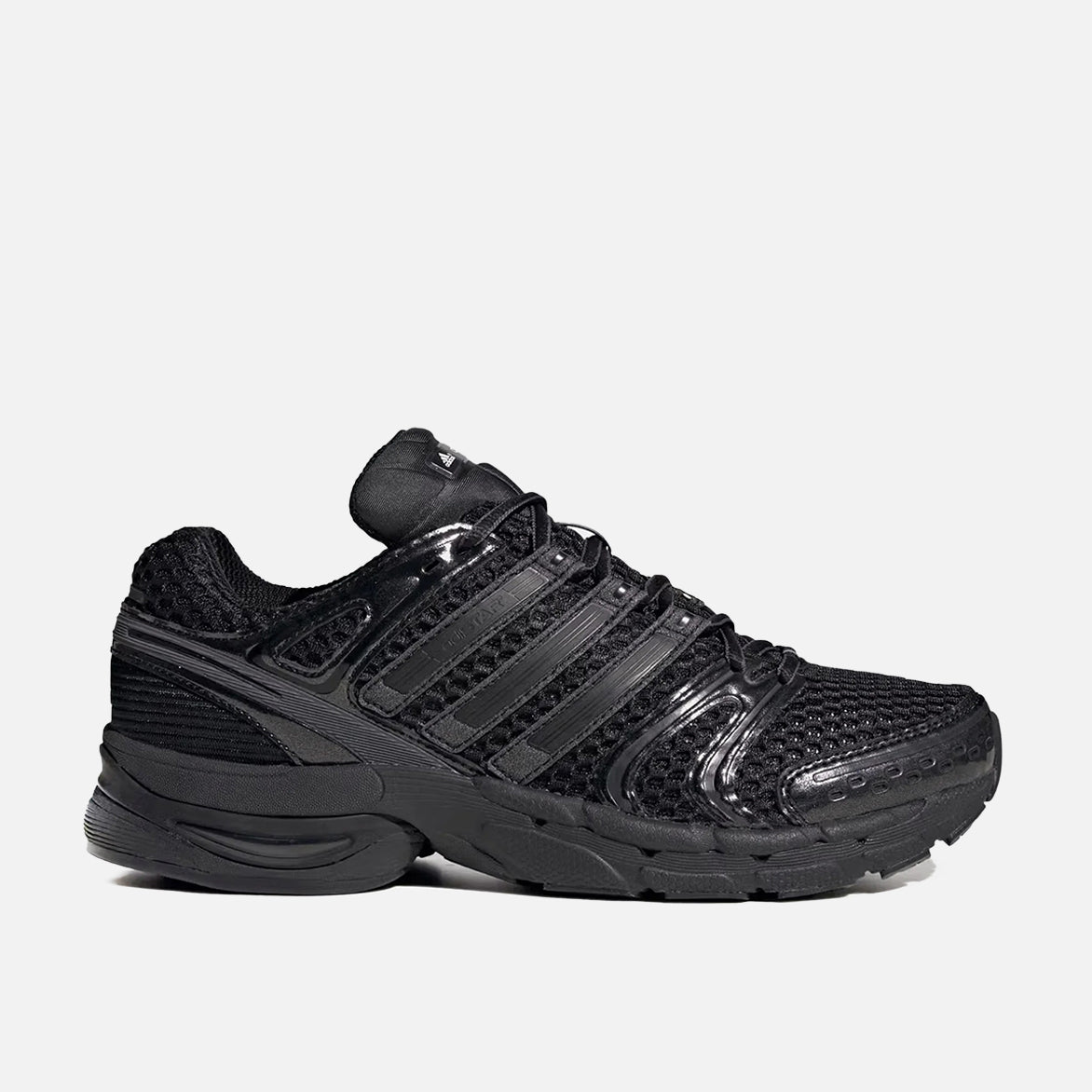 Adidas Adistar Control 5 sneakers front view showcasing black mesh upper and grey accents