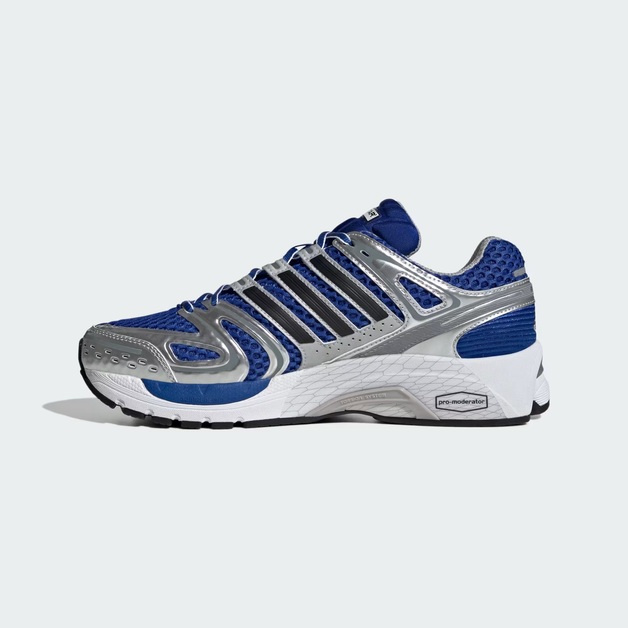 Adidas Adistar Control 5 sneakers on a running track, demonstrating their comfort and traction during a workout.