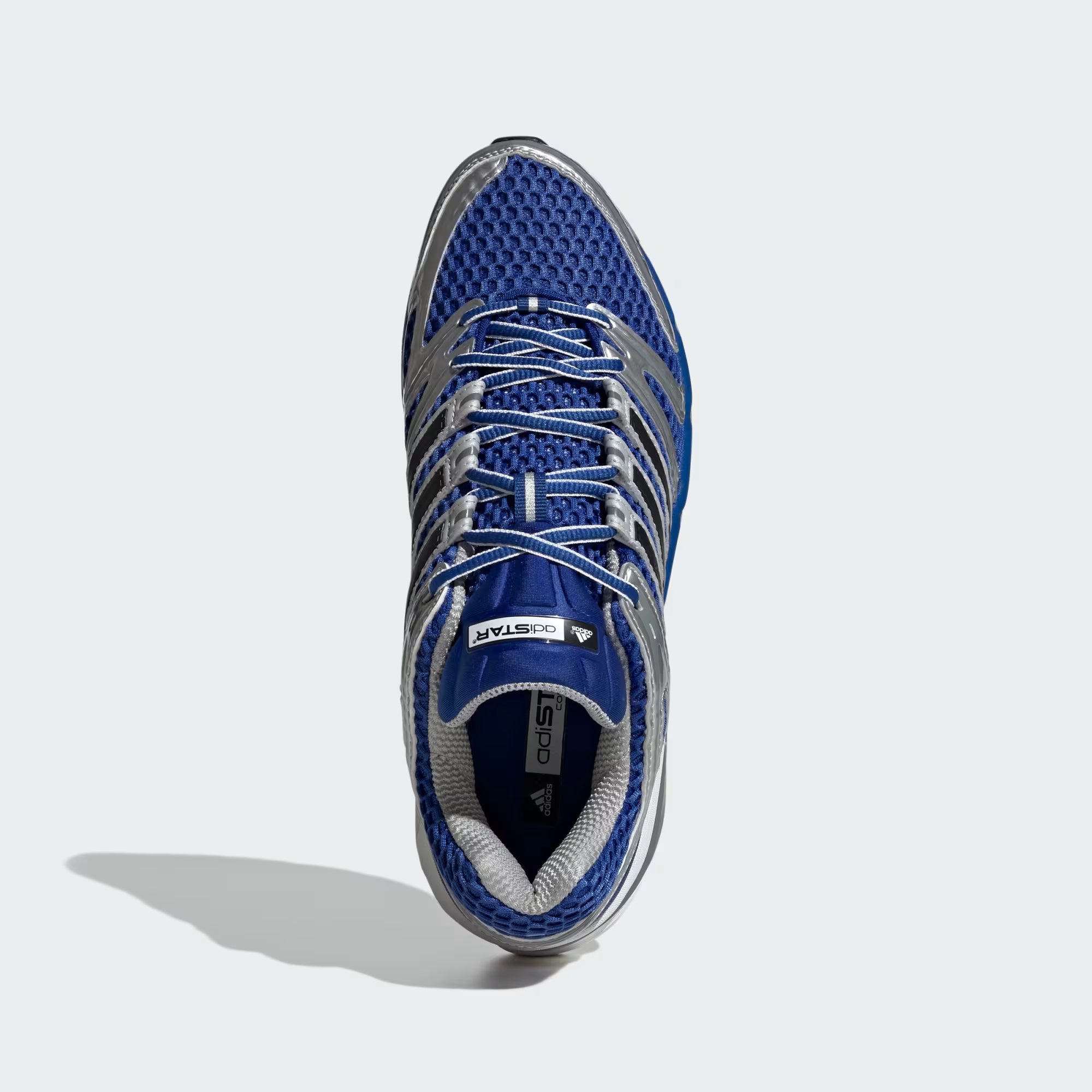 Side view of Adidas Adistar Control 5 sneakers in royal blue and silver metallic, ideal for athletic performance.