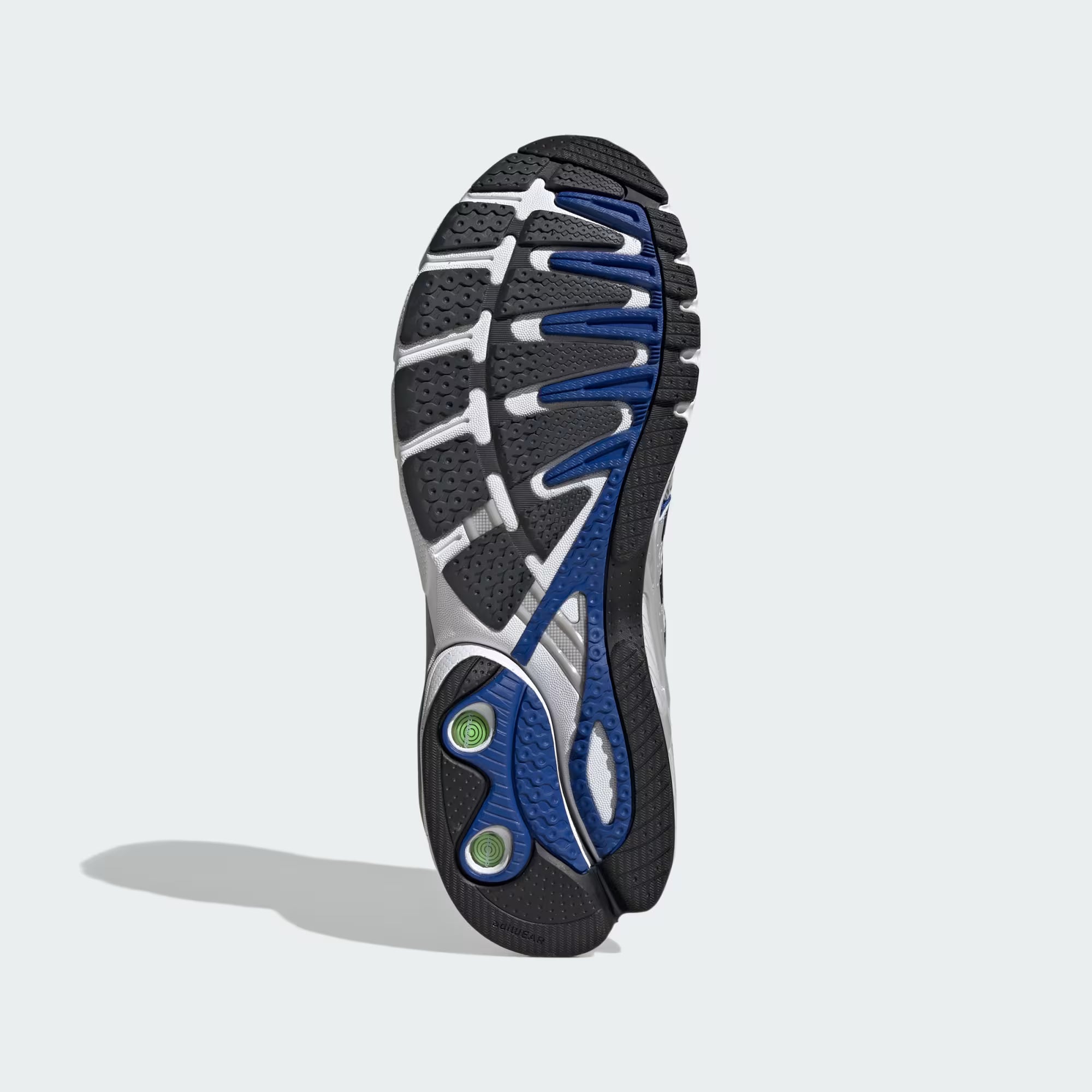 Close-up of the mesh upper and detailing of Adidas Adistar Control 5 sneakers, highlighting breathability and design.