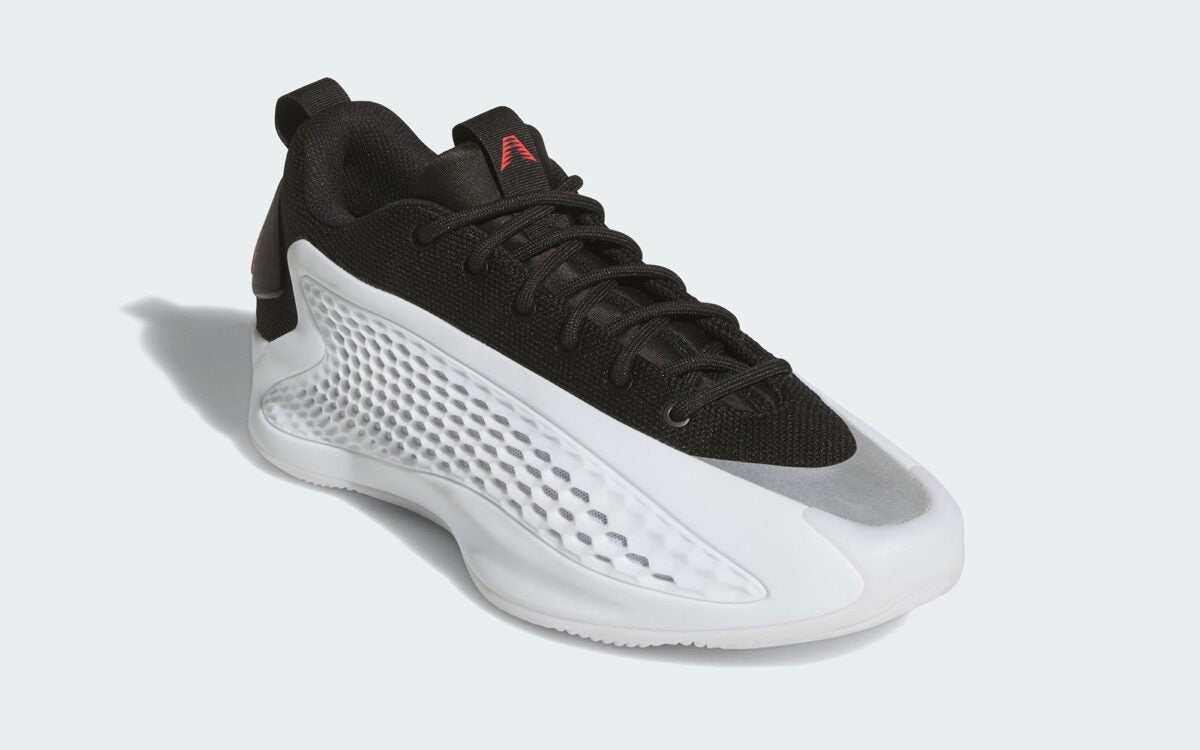 Side angle of adidas basketball shoes showing the lightweight midsole and grip outsole