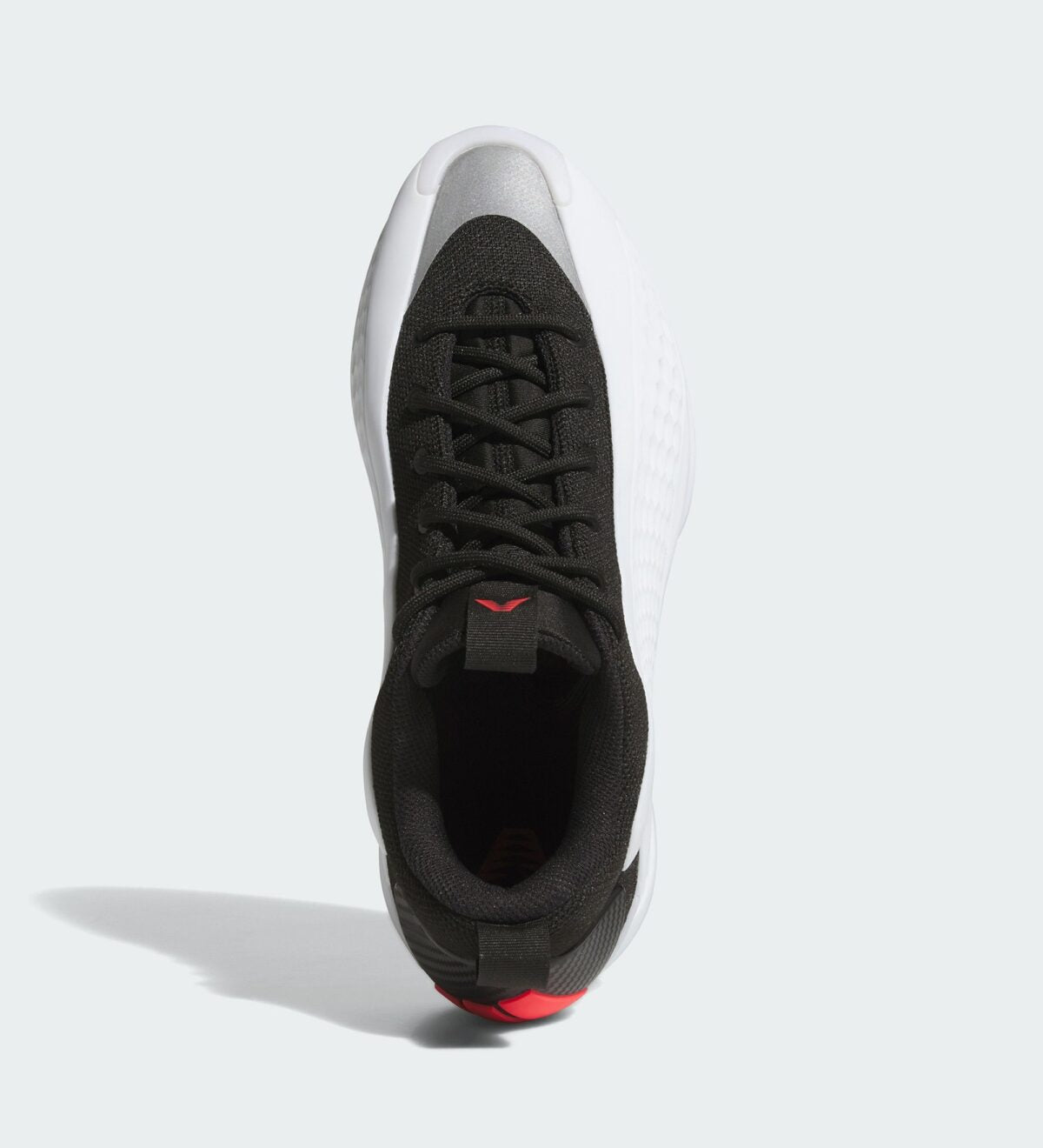 Side angle of adidas basketball shoes showing the lightweight midsole and grip outsole