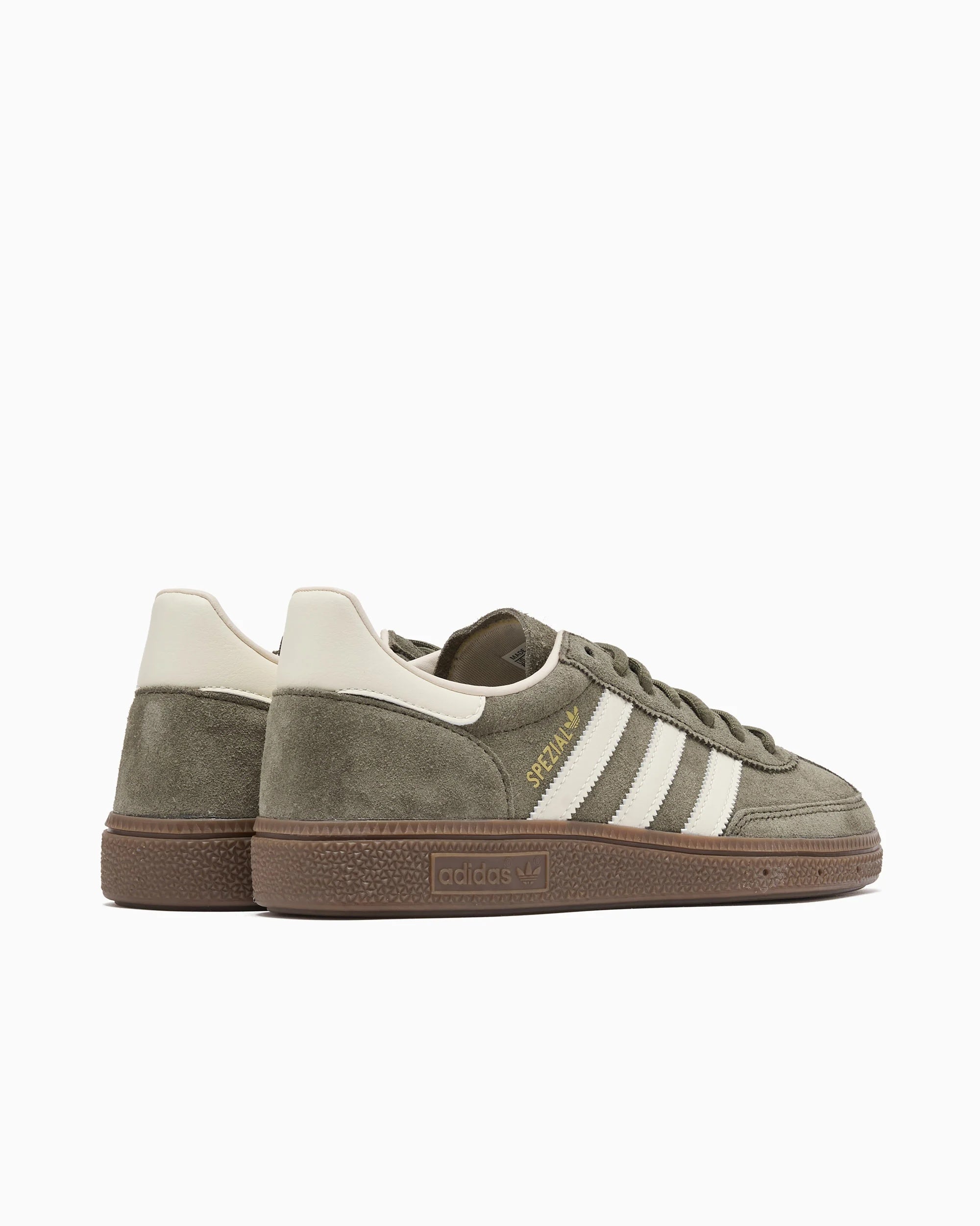 Close-up of the olive green handball sneakers showing the gold SPEZIAL detail and cream laces.