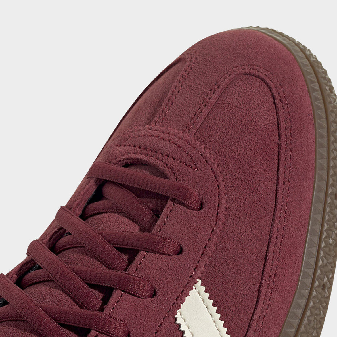Side view of retro style adidas spezial sneakers in cream and maroon
