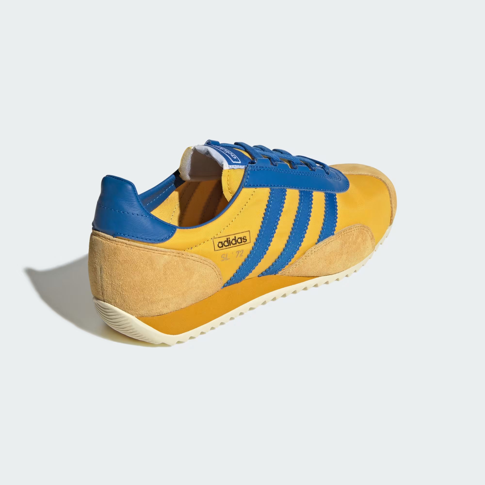 Lifestyle shot of adidas SL 72 PT shoes paired with streetwear outfit