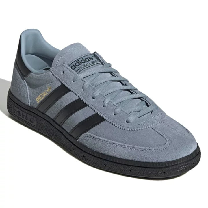 Side view of handball shoes with black rubber outsole for grip