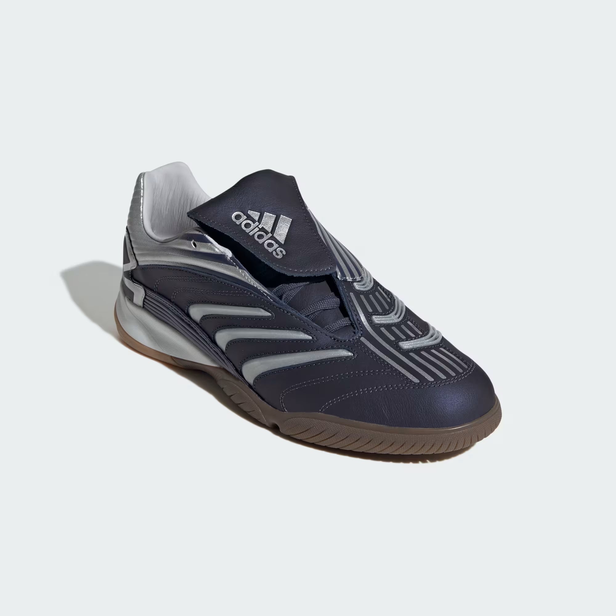 Top-down view of Adidas Predator Sala sneakers, featuring the fold-over tongue and off-center lacing for a stylish look.