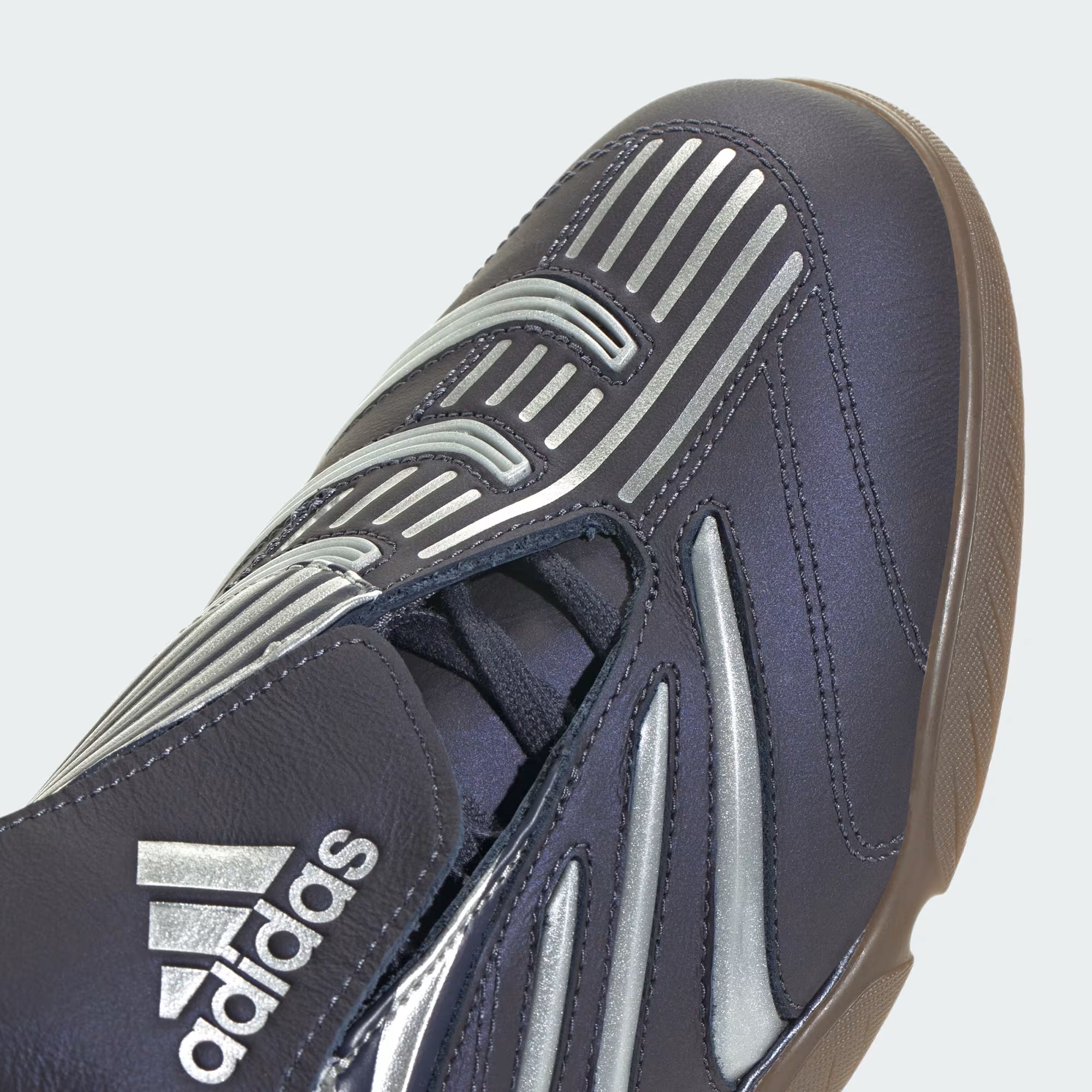 Top-down view of Adidas Predator Sala sneakers, featuring the fold-over tongue and off-center lacing for a stylish look.