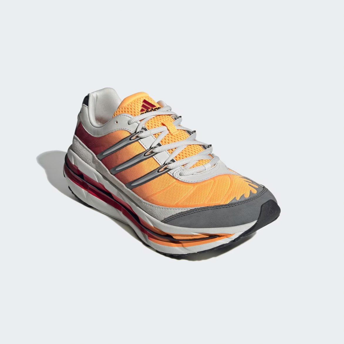 Top view of the Adidas Adistar HRMY sneakers highlighting the gradient orange mesh toe and metallic eyelets for a sporty yet casual look.