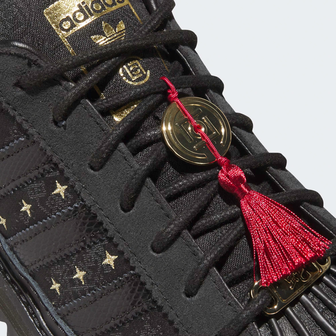 Close-up of CLOT x adidas Superstar Lunar New Year snakeskin 3-Stripes and gold star embroidery