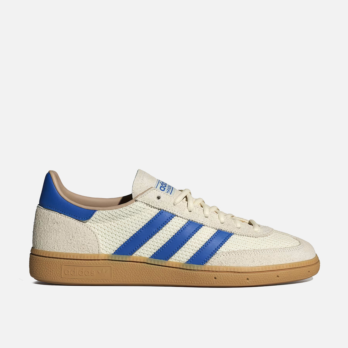 Front view of cream white and blue retro sneakers with gum outsole