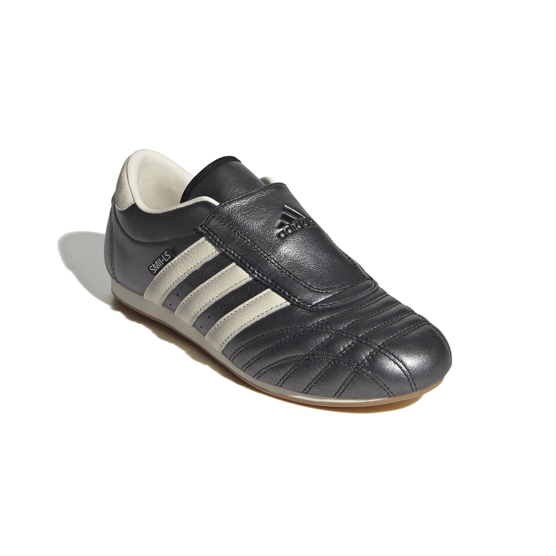 Side angle of Adidas Taekwondo shoes, emphasizing the low-profile gum rubber sole for optimal performance.