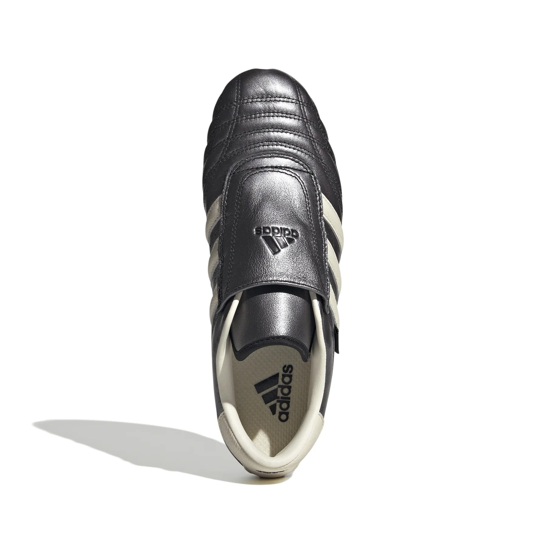 Close-up view of Womens Adidas Taekwondo Sneakers, highlighting the glossy black leather and metallic finish.