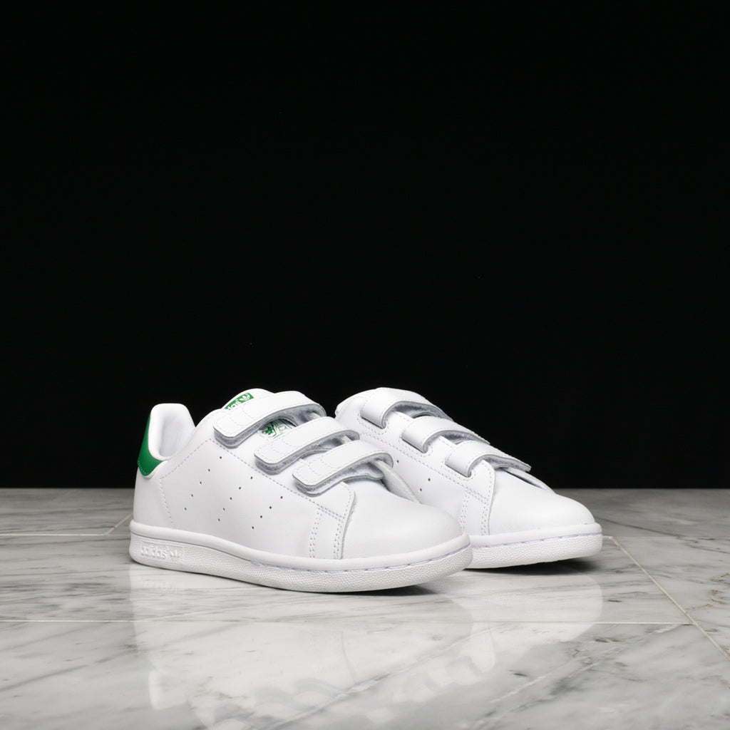 Toddler wearing adidas Stan Smith Velcro sneakers outdoors, showcasing comfort and style